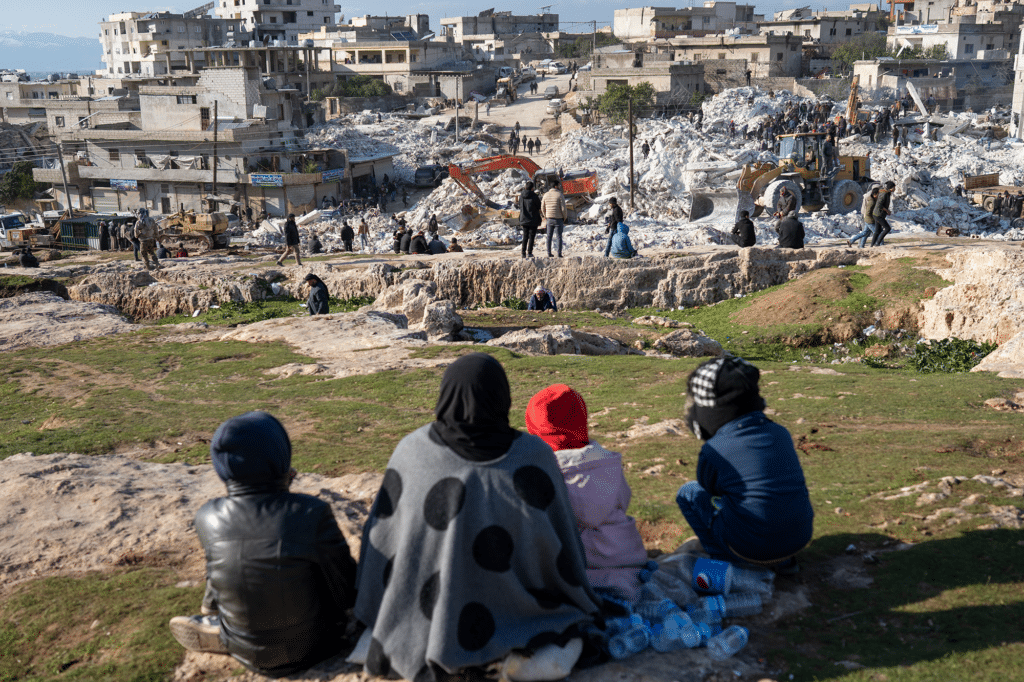 Women watch emergency crew working after Turkey Syria earthquake