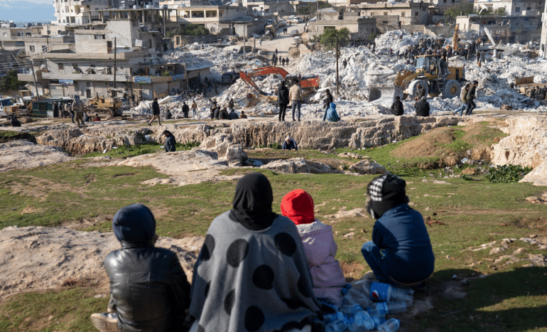 Women watch emergency crew working after Turkey Syria earthquake